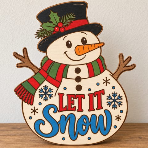 Painted Let It Snow snowman door hanger standing on a wooden table