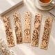 Five engraved bookmarks with a butterfly, moth, moon, bird and rose