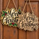 Painted and unpainted Merry Christmas holly script sign hanging side by side on a wooden door