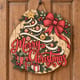 Painted round Merry Christmas sign with a ribbon-wrapped tree and big bow hanging on a wooden front door