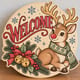 Painted round reindeer Welcome sign with jingle bells standing on a wooden table