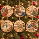 Painted nativity Christmas carol ornaments hanging on a Christmas tree