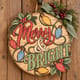Painted round Merry and Bright sign with retro Christmas lights hanging on a wooden front door