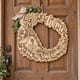 Unpainted wooden Home Sweet Home farmhouse wreath with a barn and windmill hanging on a front door