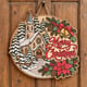 Painted round Merry Christmas sign with a snowy church hanging on a wooden front door