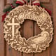 Unpainted wooden nativity Merry Christmas wreath with baby Jesus and a cross hanging on a front door