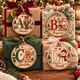 Personalized alphabet ornaments used as tags on wrapped presents