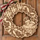 Unpainted wooden Ho Ho Ho Santa chimney wreath hanging on a front door
