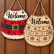 Painted and unpainted Santa belt welcome door hanger hanging side by side on a wooden door