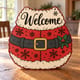 Painted Santa belt welcome door hanger standing on a wooden table