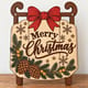 Painted Merry Christmas sled door hanger standing on a wooden table