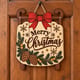 Painted Merry Christmas sled door hanger hanging on a wooden front door