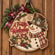 Painted round A Frosty Welcome snowman sign hanging on a wooden front door
