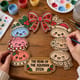Hands painting the kawaii dumpling Christmas wreath at a craft table