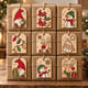 Nine painted Christmas gift tags on kraft wrapped boxes
