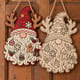 Painted and unpainted Christmas gnome door hanger with reindeer antlers hanging side by side on a wooden door