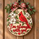 Painted round cardinal memorial sign reading I'm always with you hanging on a wooden front door