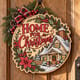 Painted round Home for Christmas sign with a snowy cottage hanging on a wooden front door
